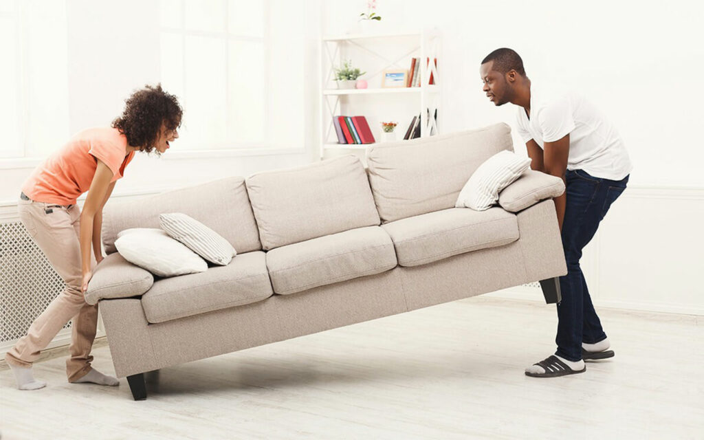 Couple moving sofa | Joseph's Flooring