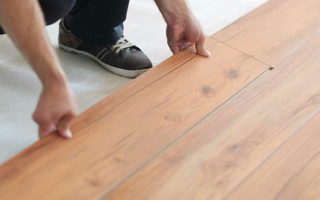 Man installing laminate floor | Joseph's Flooring
